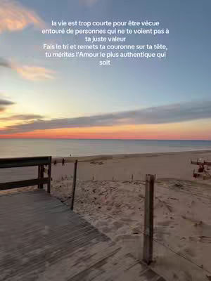 A serene beach scene at sunset, featuring a wooden walkway leading towards the shore. The sky is painted with warm colors, and the beach is bathed in a soft, golden light. Text overlayed captures the message.