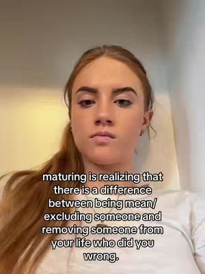 A close-up shot of a young woman with light skin and auburn hair pulled back in a ponytail. She has a neutral expression, and the text overlay is centered below her face.