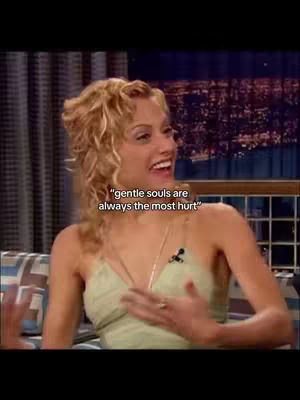 The image features a woman with curly blonde hair smiling and looking off to the side. Overlaid on the image is white text that reads, "gentle souls are always the most hurt."