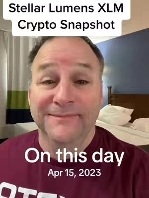 A man with a slightly smiling expression is centered in the frame, with the top portion of the image displaying text about Stellar Lumens (XLM). Below the man, there's overlay text indicating 'On this day, Apr 15, 2023.' The background is slightly blurred, showcasing a room with a bed and a dark blue wall.