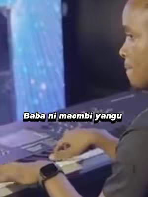 A man is seen from the side, focused on playing a keyboard or digital piano. The text on the cover says, 'Baba ni maombi yangu' which is overlaid on the image.