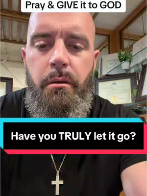 A man with a beard and a cross necklace is the primary subject of this image. Overlay text is set on a blue to red gradient background. A cross necklace is visible. The background is a light-colored room with a framed diploma and some plants.