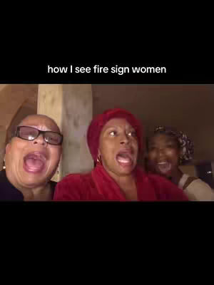 The cover image shows three women with open mouths, appearing surprised or shocked. Above them in white text, reads, "how I see fire sign women". The women, of varying ages, are positioned closely together and fill most of the frame. The woman on the left has glasses and a dark shirt, while the central woman has a red head covering and robe. The background appears dim and blurred.