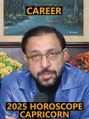 The cover image features a middle-aged man with glasses, a beard, and a dark complexion. He's wearing a blue jacket and is positioned in front of a blurred background that includes a painting and flowers. Text overlays appear at the top and bottom. The lighting is relatively even, with a focus on the man's face.