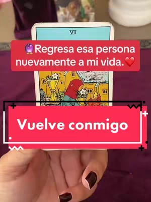A hand holds up a tarot card with the image of the 'VI' card from the Rider-Waite tarot deck. Two red banners are overlaid on the image, and a hand with black nail polish is holding the card.