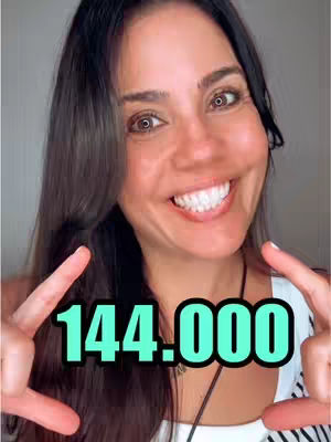 A woman smiling and pointing two fingers up to the camera. The text overlayed in the screen displays the number 144,000 in a green background.