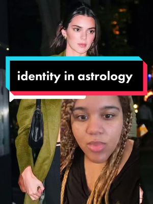 The cover image is a split screen. The top half shows Kendall Jenner in an outdoor setting, dressed in a green coat and black outfit. The bottom half features a selfie of a woman with blonde and brown braided hair, looking towards the center. A text overlay states "identity in astrology" in a white font within a teal text box.