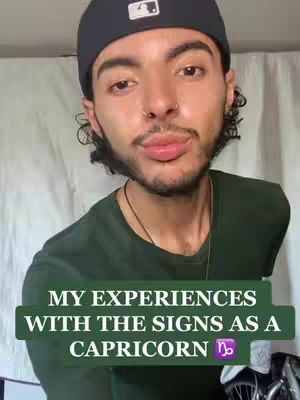 A man in a black baseball cap and a dark green shirt is looking towards the camera with pursed lips. The text overlay reads 'MY EXPERIENCES WITH THE SIGNS AS A CAPRICORN' featuring a Capricorn symbol.
