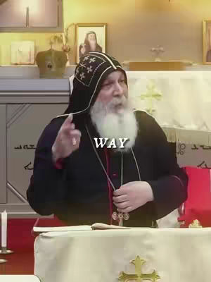 The image features a close-up of a man with a white beard and a black hat with white cross-shaped patterns on it. He's wearing dark clothing and a cross necklace. The word 'WAY' is overlaid on the image in white text. The background is a room with religious artifacts and decorations.