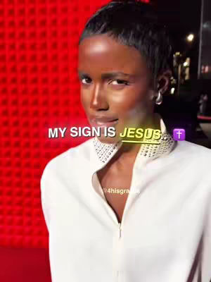 The image features a woman with a short haircut, smiling, and looking towards the camera, a text overlay is visible above her head.