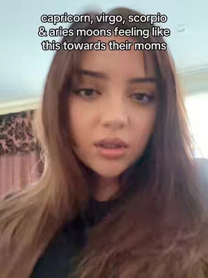 A close-up shot of a young woman with long brown hair, looking slightly downward with a neutral expression. Text overlayed above the woman indicates the video's focus on astrology and relationships.