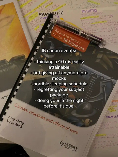 The image shows a textbook opened on a desk with several notebooks and highlighted notes scattered around. A pen rests on top of the book. The main text overlay lists common International Baccalaureate (IB) experiences.
