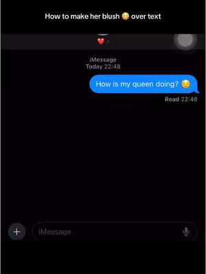 A phone screen displays a black background with a text conversation. At the top, white text reads "How to make her blush" with a blushing emoji. Below, an iMessage conversation bubble in blue states "How is my queen doing?" with a smiling emoji. Underneath, the time "Read 22:48" appears in small text. The interface suggests a texting tutorial or a relatable scenario regarding relationships.