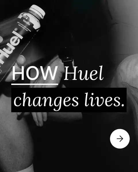 A black and white image with overlaid text and a call to action. In the foreground, a person is holding a bottle of Huel, which is in focus, the bottle is labeled as Vanilla. The text reads 'HOW Huel changes lives' in a bold, sans-serif font. A black rectangle lays underneath the text. In the bottom right corner, there's a white circle with a right-pointing arrow.