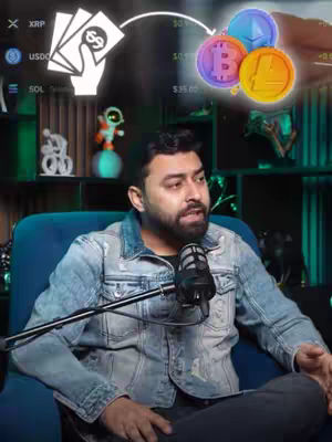 A man in a denim jacket sits in a blue chair, speaking into a microphone. The background includes a screen and shelves with decorative items. Animated graphics of cryptocurrency coins and a hand holding money are overlaid in the image.