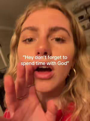 A close-up shot of a young woman with blonde hair, looking towards the camera with a hand raised towards her face. Her hand is positioned in front of her mouth, with only fingers and a little of her palm visible. Overlayed text reads: "Hey don't forget to spend time with God". The background is out of focus.