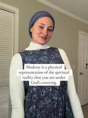 A woman with a blue head covering and a modest floral dress, overlaid with text. Soft lighting and a neutral background creates a serene atmosphere.