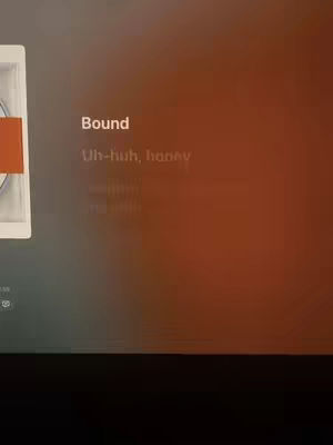The cover image shows a screen with a blurred orange and grey background. Text is overlaid, with the song title 'Bound' and lyrics from the song.