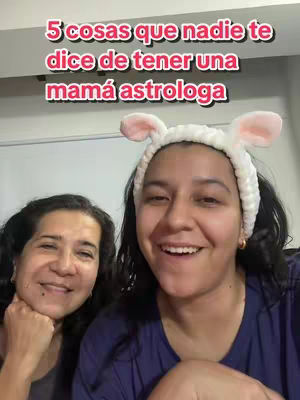 A selfie-style shot features two women smiling, set against a simple indoor backdrop. The woman on the right wears a white headband with bunny ears. Text overlaid reads, '5 cosas que nadie te dice de tener una mamá astrologa'.