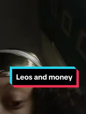 The cover image has a dark, blurred background with the lower part of a face visible, possibly a woman's, with a blurred silver object above. Overlaid is a rectangular text box in alternating colors, with the text 'Leos and money'.