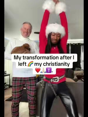 The image shows two people in a room. On the left stands a man in white turtleneck sweater paired with plaid pants, holding a puppy. On the right, a person with long dark hair wearing a Santa hat and red top with black leather pants dances with arms raised.