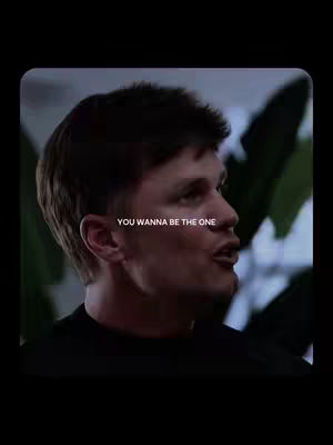 A man's profile is featured, set against a blurred background of greenery. Text is overlaid on the image, with a black border encompassing the frame.