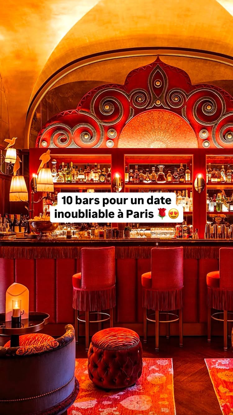 The image presents a bar scene with a vibrant red and gold color scheme. The central focus is the bar itself, which is lined with bottles and glasses, indicating a selection of drinks. Underneath, there are red bar seats with fringed backs, with the rest of the interior featuring warm red decor. The image overall suggests a luxurious and inviting atmosphere.