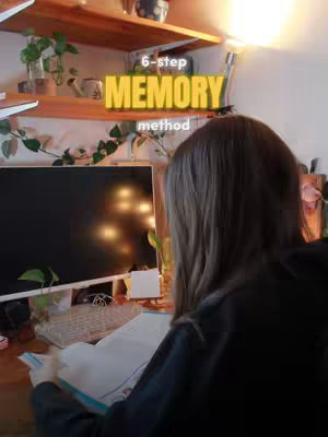 A woman seen from behind is studying at a desk with a computer and books. The image is warm-toned, and overlaid text provides the video's hook.