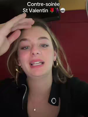 A woman with blonde hair and hoop earrings gestures towards the camera with her hand up. Text overlays at the top read "Contre-soirée St Valentin".