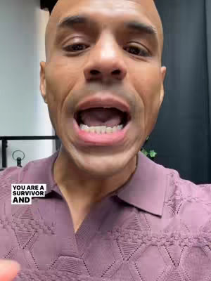 A close-up of a bald Black man with an open mouth, speaking directly to the camera. The background is a blurred interior setting. Text overlay appears in a white box in the lower left corner.
