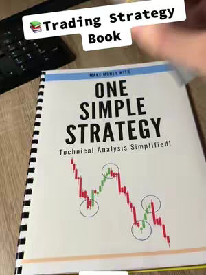 The image shows a person holding a book with the title "ONE SIMPLE STRATEGY". The book’s cover includes a graph of red and green candlestick charts with circular annotations. The background includes a wooden surface and a keyboard.