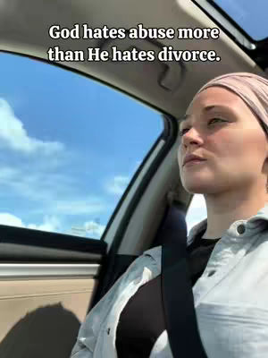 A woman is seen from the chest up while in a vehicle. The sky is blue and cloudy. Text overlay on the top of the image.