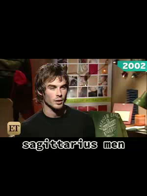 The cover image shows a man with brown hair, wearing a black shirt, in what appears to be a television interview setting. Text overlayed at the bottom reads 'sagittarius men'. Behind the man, a wall with several pictures and a sign reading '2002' highlights the old video footage.
