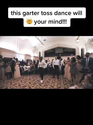 The video shows a wedding reception scene. A person is in the middle of a dance floor performing. There are several people in the background that are watching the dance. The upper portion of the image has a text bar with text and an emoji.