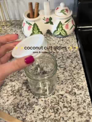 A hand holding a glass jar with a white lid against a background of a speckled countertop. Text overlays the image, with a decorative ceramic piece in the background.