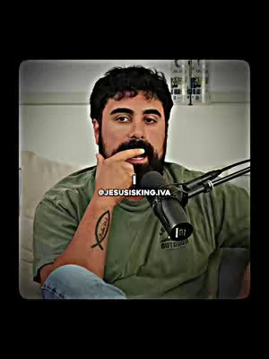 The cover image shows a man in a green shirt, sitting in front of a microphone. He has a beard and a tattoo on his arm, and he’s touching his face with one finger.