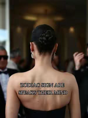 Image from behind of a woman with her hair up in a bun and a strapless black dress. Text stating, "ZODIAC SIGNS ARE SPEAKS THEIR MIND", is overlaid on the woman's back.