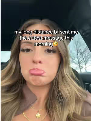 A woman with long blonde hair is shown with a slightly pouting expression. The background suggests the inside of a vehicle, and text overlays the image.