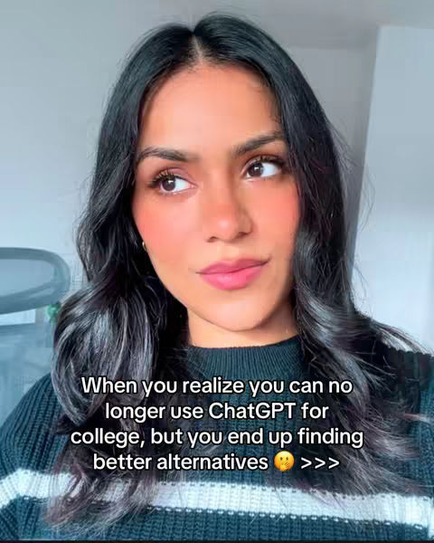 A selfie-style shot of a woman with dark hair and a neutral expression looking towards the left side of the frame. She is wearing a dark sweater with white stripes at the bottom. Text overlayed on the image says 'When you realize you can no longer use ChatGPT for college, but you end up finding better alternatives.'