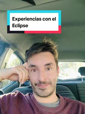 A man is seated inside a car, his face centered in the image. The man has a slightly open mouth and a neutral expression. A teal and red text overlay is at the top, reading "Experiencias con el Eclipse." The car interior is visible in the background.