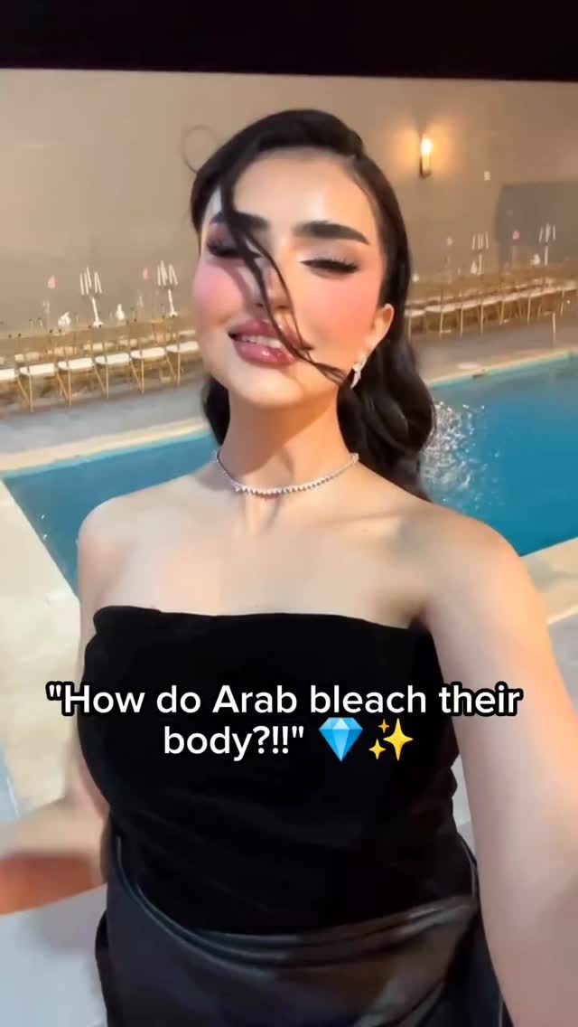 The cover image features a woman smiling and looking towards the camera with a blurred outdoor background. She is wearing a black strapless top, a silver necklace, and earrings. The text overlay at the bottom reads ""How do Arab bleach their body?!"" followed by a diamond emoji and star sparkles.