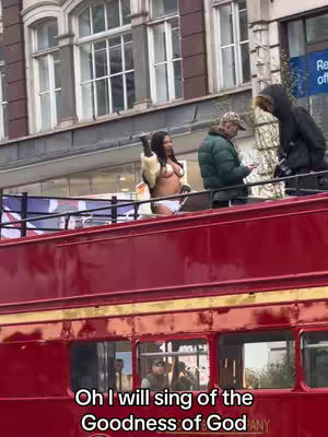 The cover image shows a woman standing atop a red double-decker bus in a city setting. She's dressed in lingerie underneath a fur coat, with other people visible in the background around the bus. The bottom of the image displays the text overlayed as the hook.