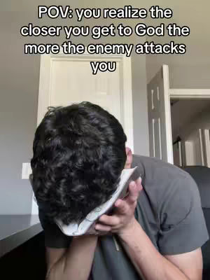 The cover image shows a person, viewed from behind, with dark, curly hair. They are wearing a dark t-shirt and covering their face with a piece of paper or some other material. Behind them, a white door and a section of a grey wall are visible. Above is white text.