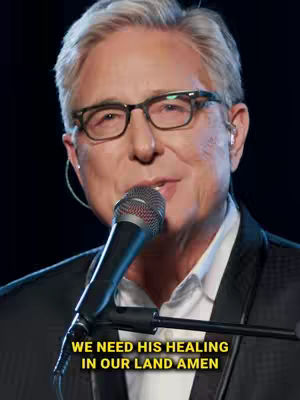 The cover image features a man with gray hair wearing glasses and a suit jacket holding a microphone. Text overlayed on the image reads, "WE NEED HIS HEALING IN OUR LAND AMEN".