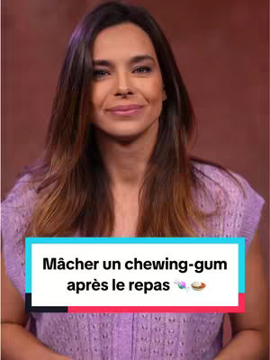 A medium shot of a woman with long, wavy brown hair, looking directly at the camera with a slight smile. She's wearing a light purple, textured top. Below her, a rectangular text overlay with a black background displays white text about chewing gum.