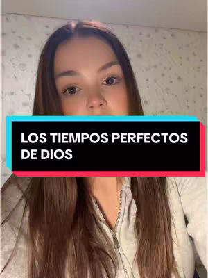 A selfie-style shot of a woman with long brown hair against a blurred background. A text overlay in a vibrant box divides the image horizontally, declaring 'LOS TIEMPOS PERFECTOS DE DIOS' in white letters against a colorful background. The woman is centered and looking directly at the camera.