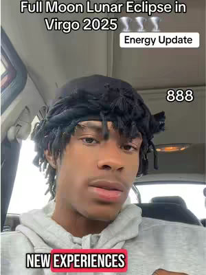 A selfie-style image featuring a young Black man in a grey hoodie set in a car interior. The man has short dreadlocks and is looking at the camera. Text overlays read "Full Moon Lunar Eclipse in Virgo 2025" at the top, "Energy Update". "888" is displayed in the upper right corner. A text overlay at the bottom reads "NEW EXPERIENCES" inside a red rectangle.