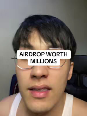 A close-up shot of a young man wearing glasses. A white rectangle with black text reading "AIRDROP WORTH MILLIONS" is superimposed over his face. The background is a blurry, neutral color.