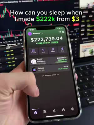 A hand holding a smartphone displaying an app interface. The screen shows financial data including a large sum of money and a percentage increase. There's a background of computer screens with charts. The overall colors are various shades of green and black.