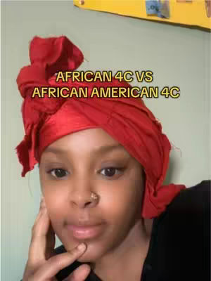 A close-up shot of a Black woman with her hair wrapped in a red headwrap. The woman is looking at the camera. Yellow and green background. Text overlayed on the image reads: 'AFRICAN 4C VS AFRICAN AMERICAN 4C'.
